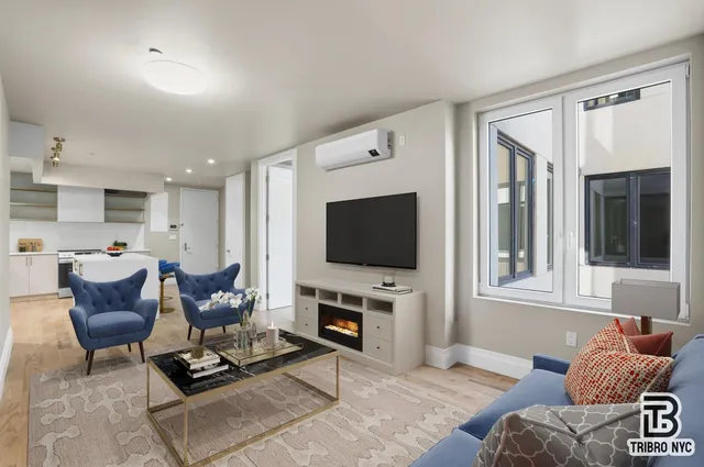a living room with furniture a flat screen tv and a fireplace