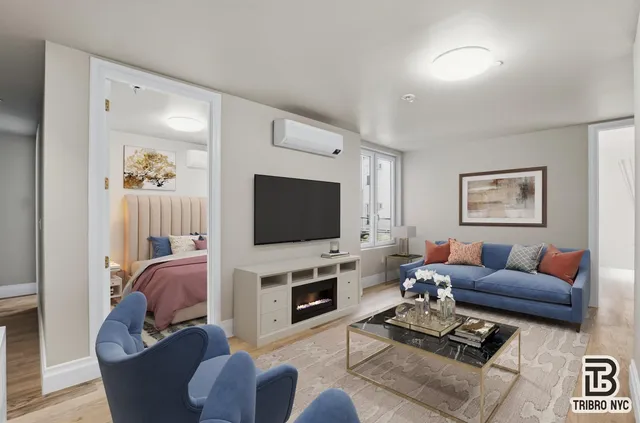 a living room with furniture a flat screen tv and a fireplace