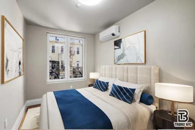 a bedroom with a bed a mirror and a window