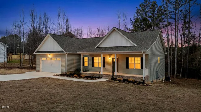 an aerial view of a house with swimming pool and porch