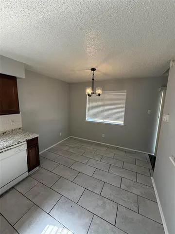 a view of a kitchen with a sink and a stove top oven
