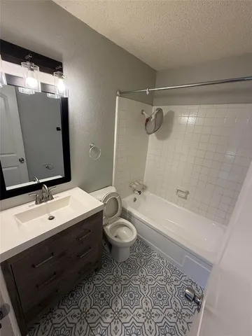 a bathroom with a double vanity sink toilet mirror and bathtub