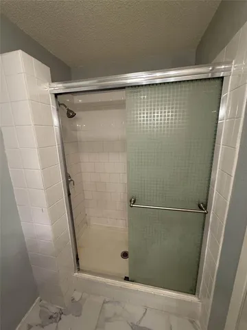 a bathroom with a glass door shower