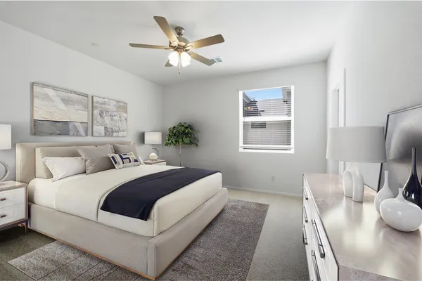 a bedroom with a large bed and a chandelier