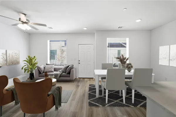 a living room with furniture wooden floor and a potted plant