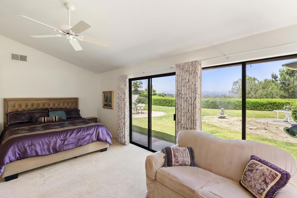 2221 Cortina Circle Escondido, CA 92029 - Photo 16 of 36 a bedroom with a large bed couch and a large window