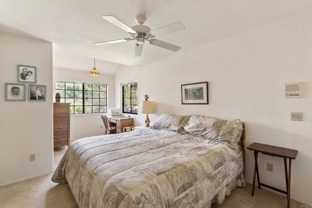 2221 Cortina Circle Escondido, CA 92029 - Photo 20 of 36 a bedroom with a large bed and a window