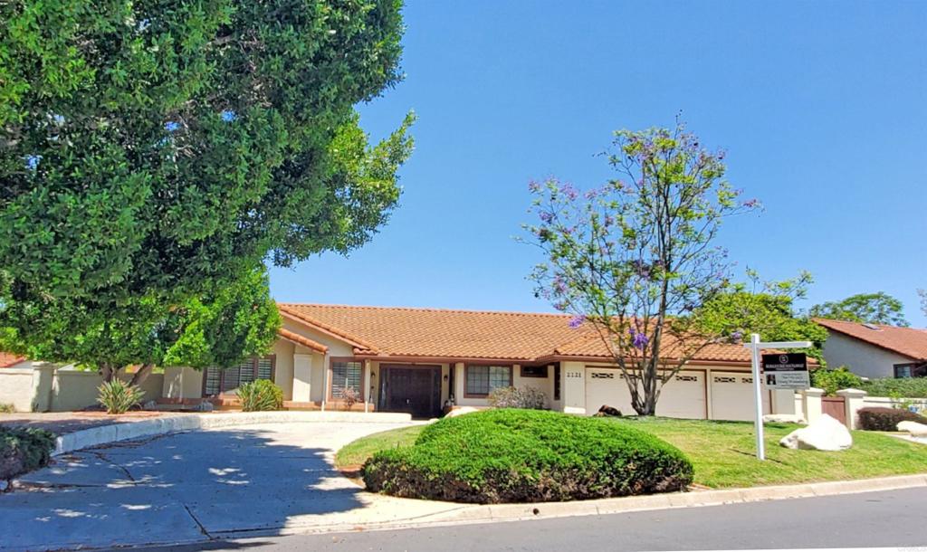 2221 Cortina Circle Escondido, CA 92029 - Photo 3 of 36 an outdoor view of a house with a yard