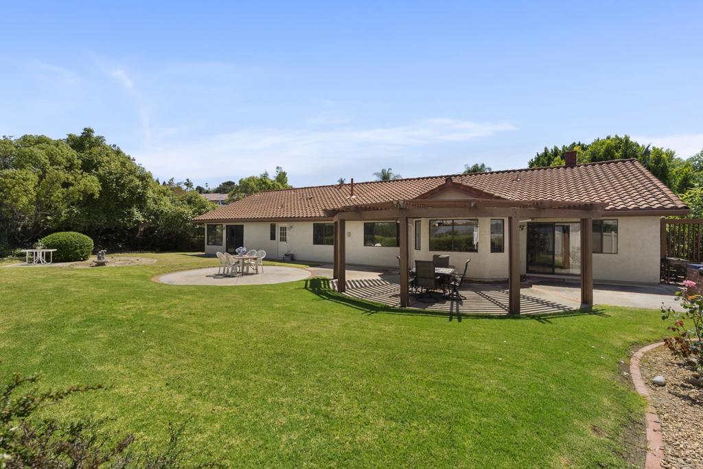 2221 Cortina Circle Escondido, CA 92029 - Photo 31 of 36 a front view of a house with garden and sitting area
