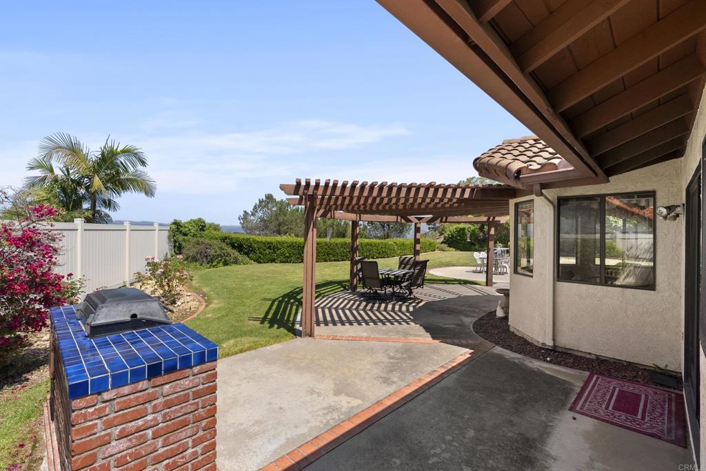 2221 Cortina Circle Escondido, CA 92029 - Photo 33 of 36 a view of a patio with couches table and chairs and potted plants