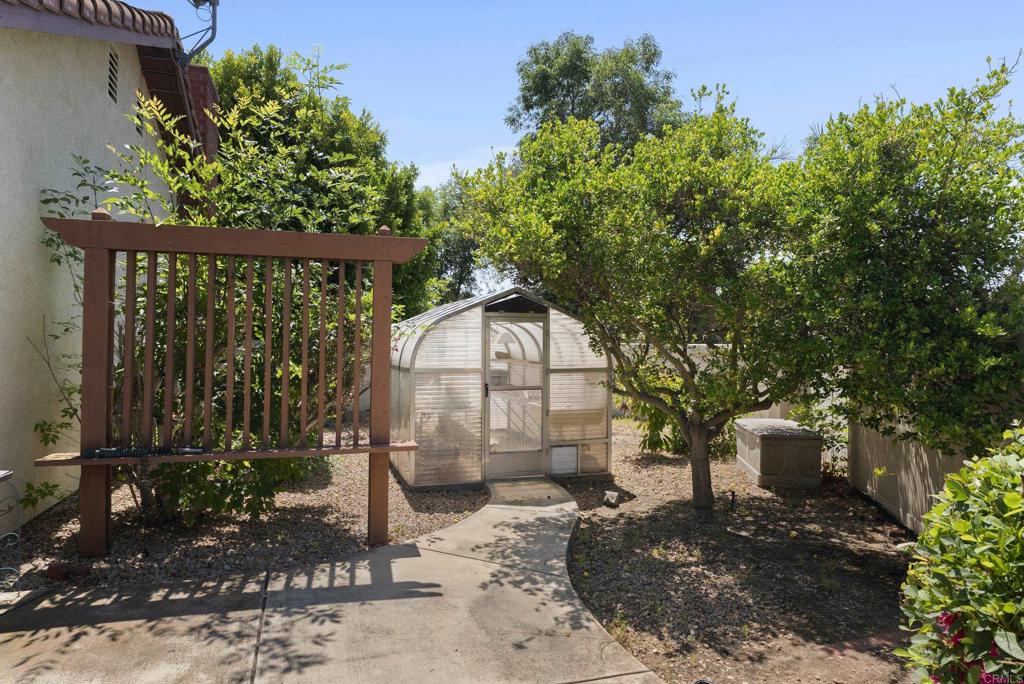 2221 Cortina Circle Escondido, CA 92029 - Photo 35 of 36 a front view of a house with garden