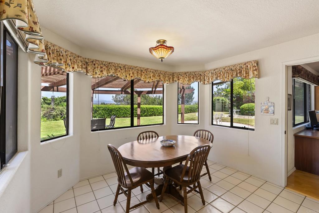 2221 Cortina Circle Escondido, CA 92029 - Photo 9 of 36 a dining room with furniture a chandelier and window