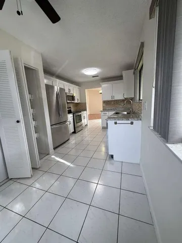 a kitchen with stainless steel appliances a refrigerator sink and stove