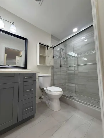 a bathroom with a toilet a sink and shower