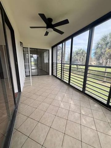 a view of a livingroom with a ceiling fan and window