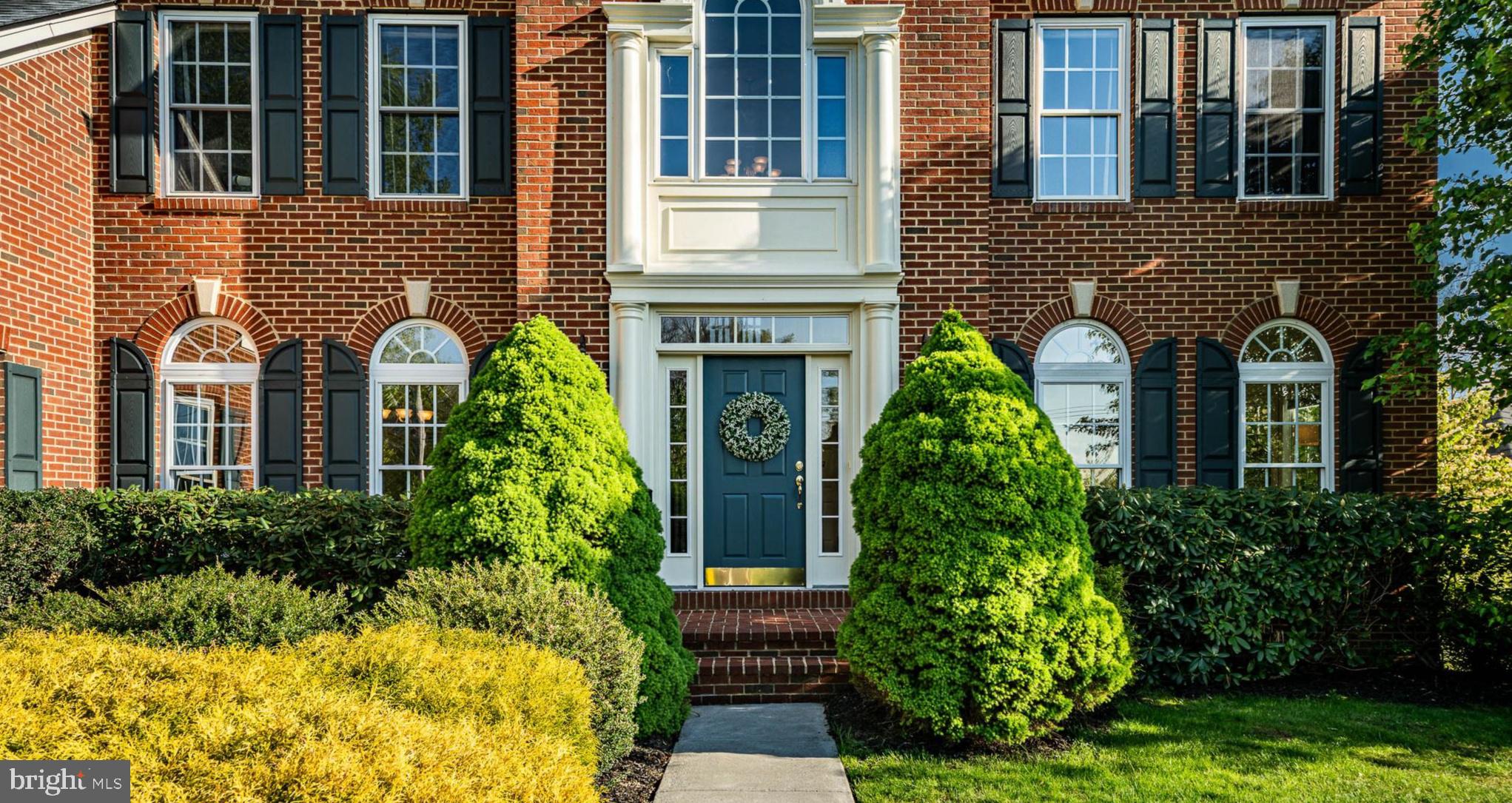 12 Schofield Road Phoenixville, PA 19460 - Photo 76 of 76 Charming brick facade with lush greenery.