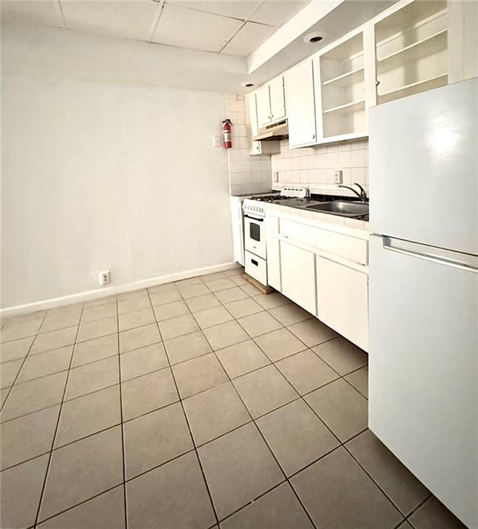 1447 Oxford Road Northeast Atlanta, GA 30307 - Photo 2 of 8 a kitchen with white cabinets and white appliances