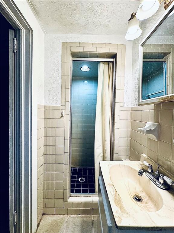 1447 Oxford Road Northeast Atlanta, GA 30307 - Photo 6 of 8 a bathroom with a sink and a mirror