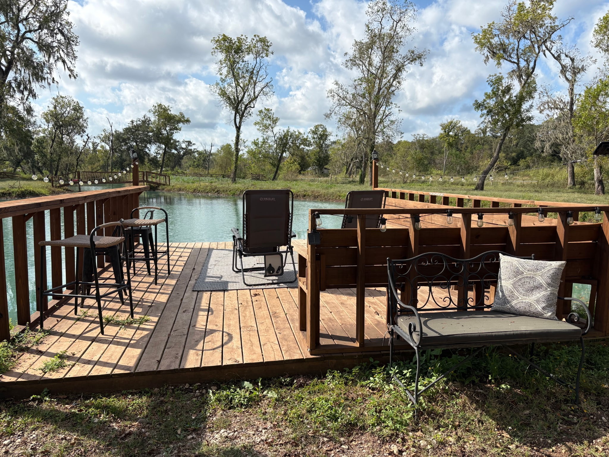 a view of a wooden chairs and table on the deck