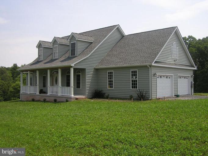 2150 Whitacre Road Cross Junction, VA 22625 - Photo 1 of 1 a front view of a house with a yard and garage