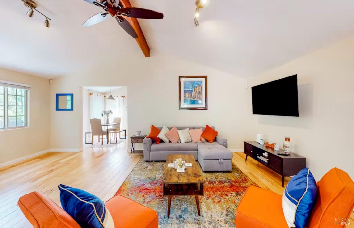 Living room with vaulted ceiling and open beam