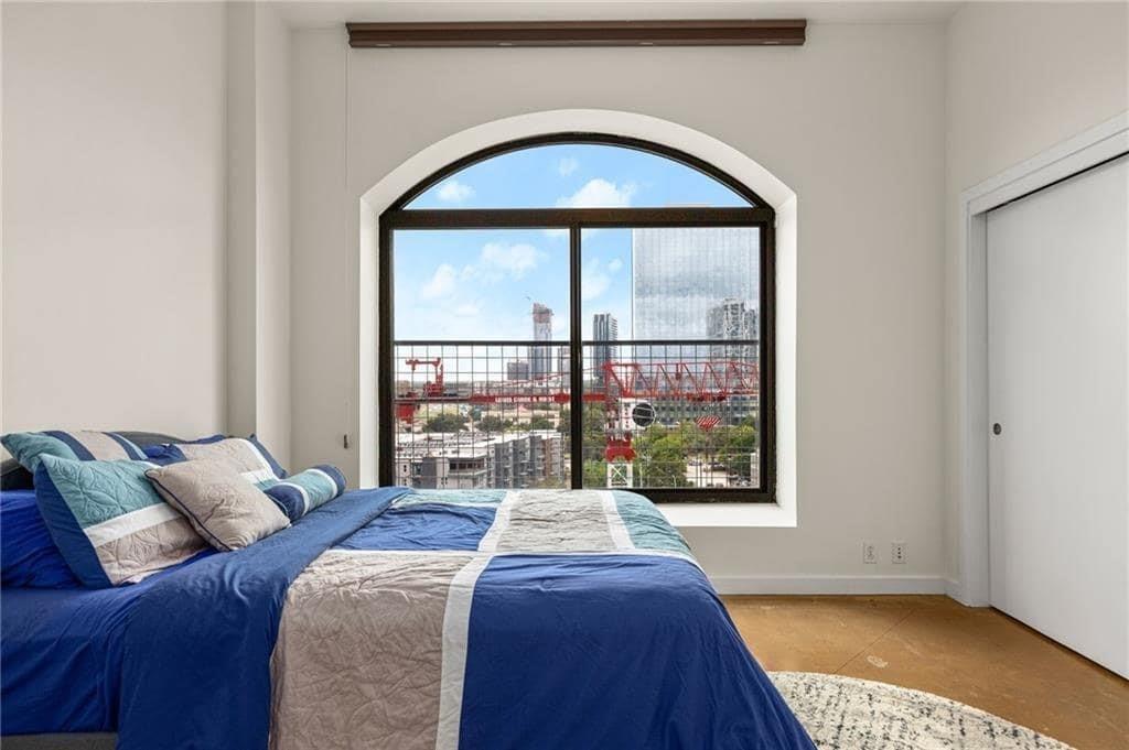 507 Sabine Street, Unit 705 Austin, TX 78701 - Photo 15 of 32 a bed sitting in a bedroom next to a window