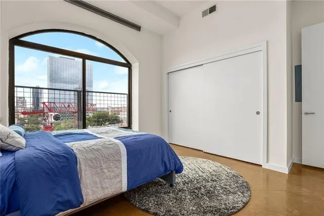 a bedroom with a large bed and a large window