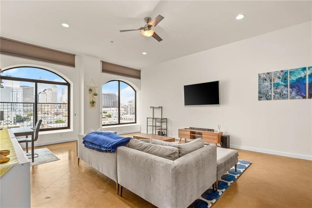 507 Sabine Street, Unit 705 Austin, TX 78701 - Photo 19 of 32 a living room with furniture and a flat screen tv