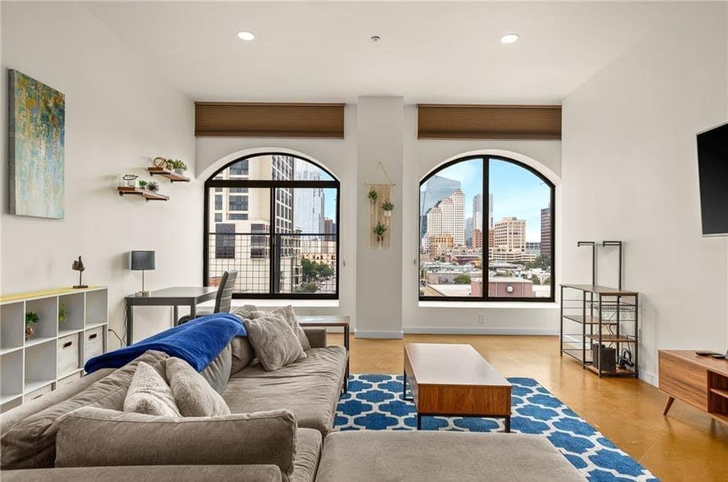 507 Sabine Street, Unit 705 Austin, TX 78701 - Photo 2 of 32 a living room with furniture and a large window