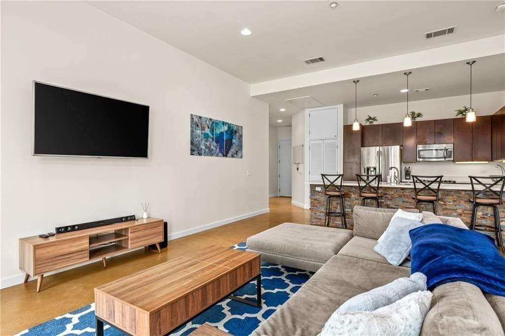 507 Sabine Street, Unit 705 Austin, TX 78701 - Photo 21 of 32 a living room with furniture and a flat screen tv