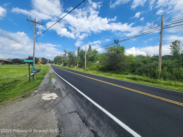 a view of a road with a big yard