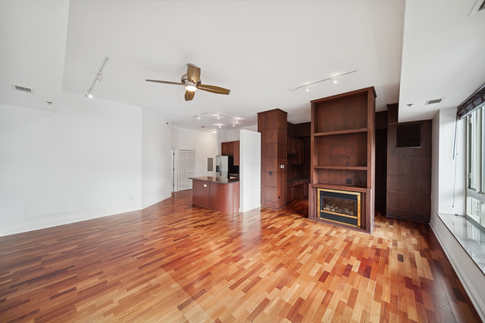 230 West Division Street, Unit 501 Chicago, IL 60610 - Photo 11 of 27 a view of a kitchen with a stove refrigerator and wooden floor
