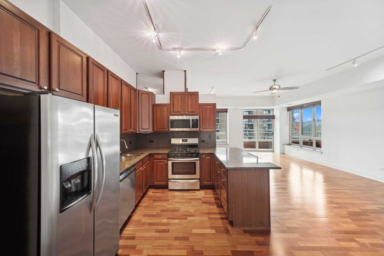 230 West Division Street, Unit 501 Chicago, IL 60610 - Photo 12 of 27 a kitchen with stainless steel appliances granite countertop a refrigerator stove and oven