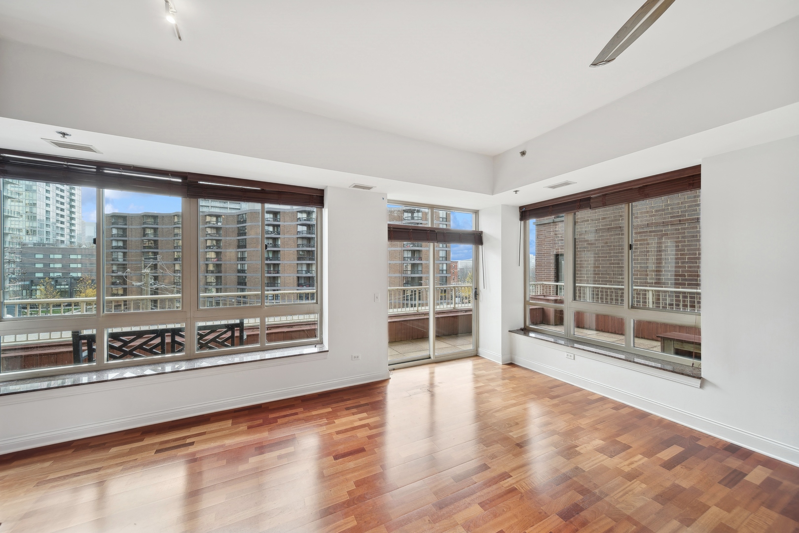 230 West Division Street, Unit 501 Chicago, IL 60610 - Photo 13 of 27 a view of an empty room with a window and wooden floor