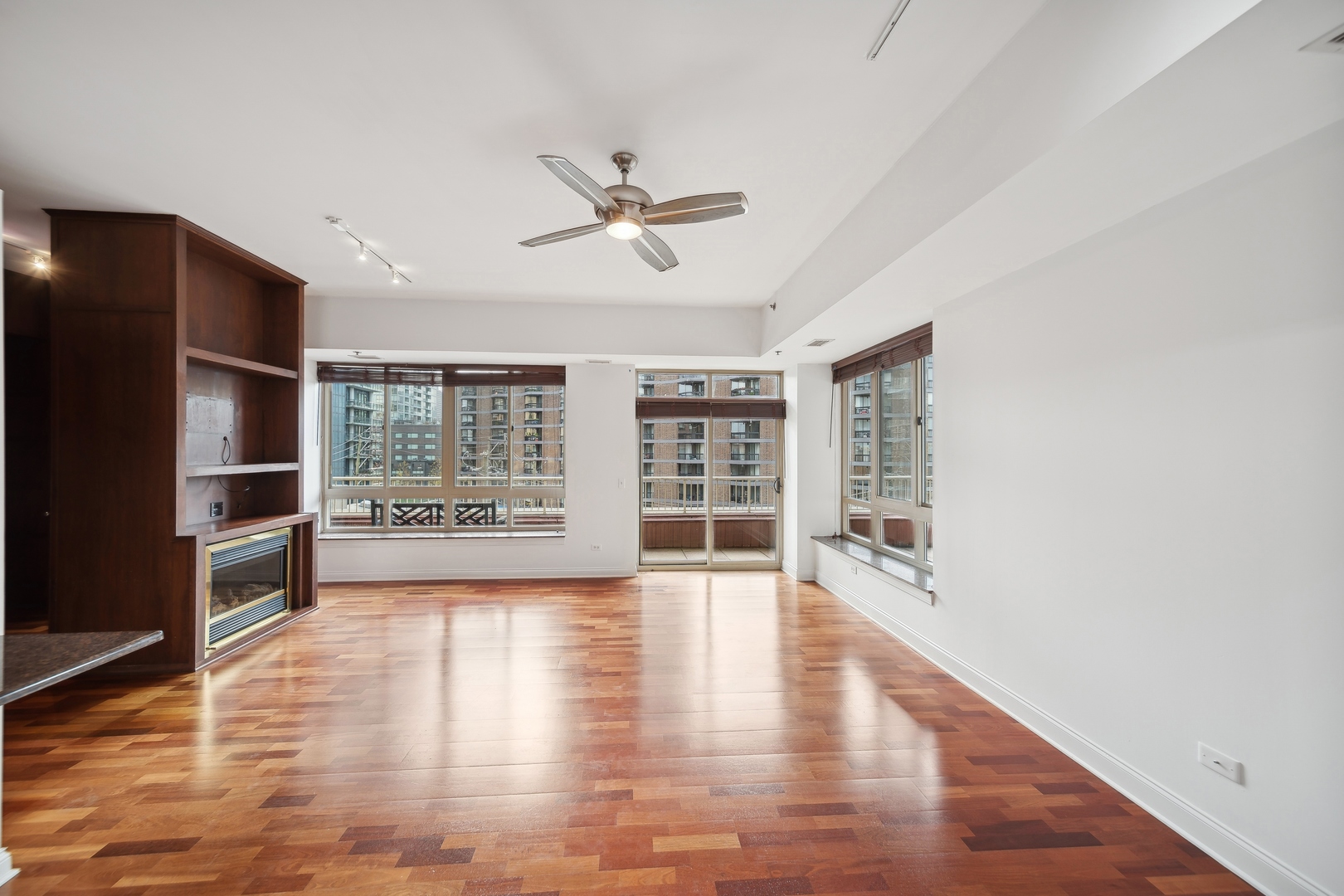 230 West Division Street, Unit 501 Chicago, IL 60610 - Photo 14 of 27 a view of an empty room with a window and wooden floor