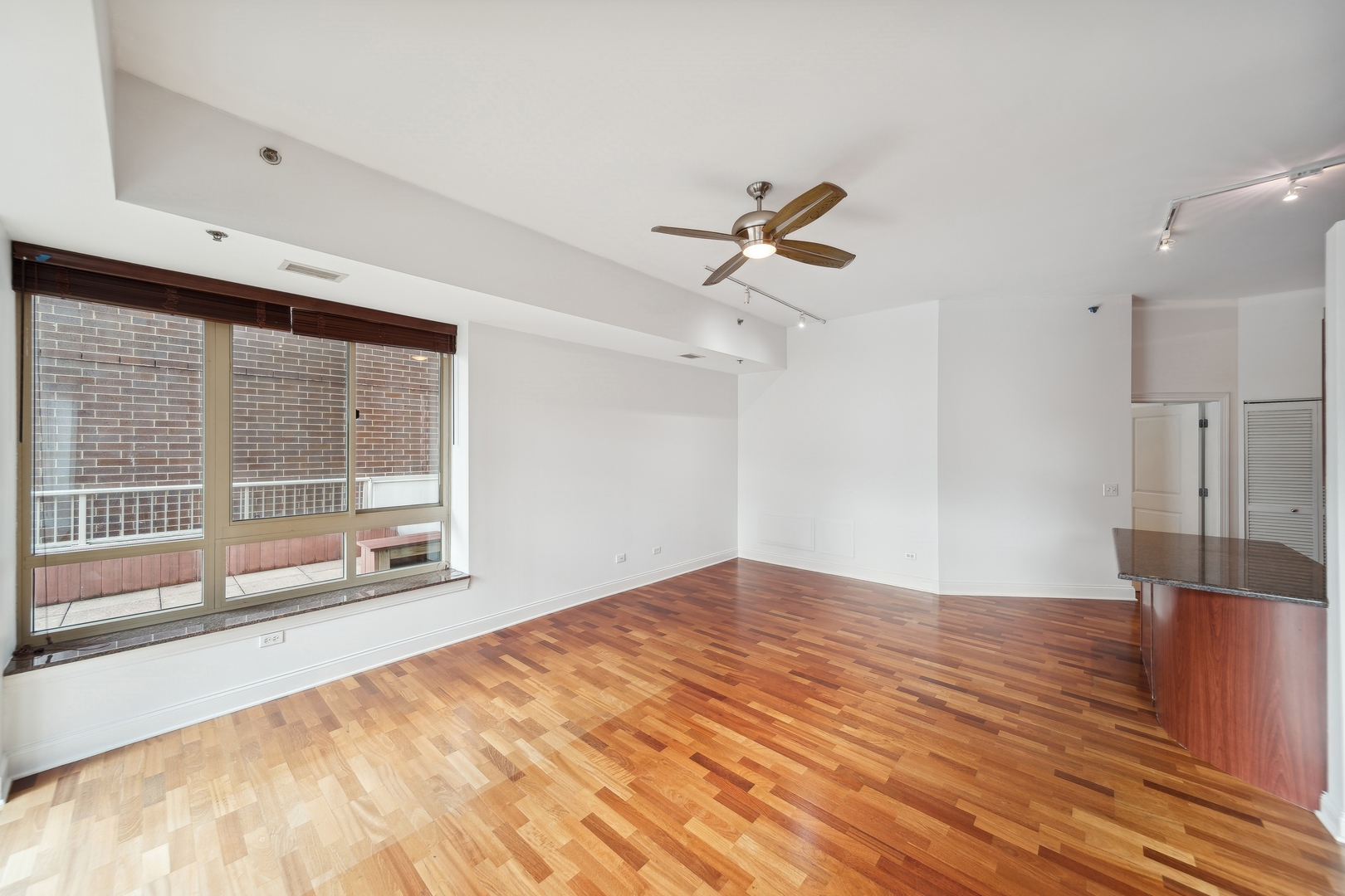 230 West Division Street, Unit 501 Chicago, IL 60610 - Photo 16 of 27 a view of empty room with wooden floor and fan