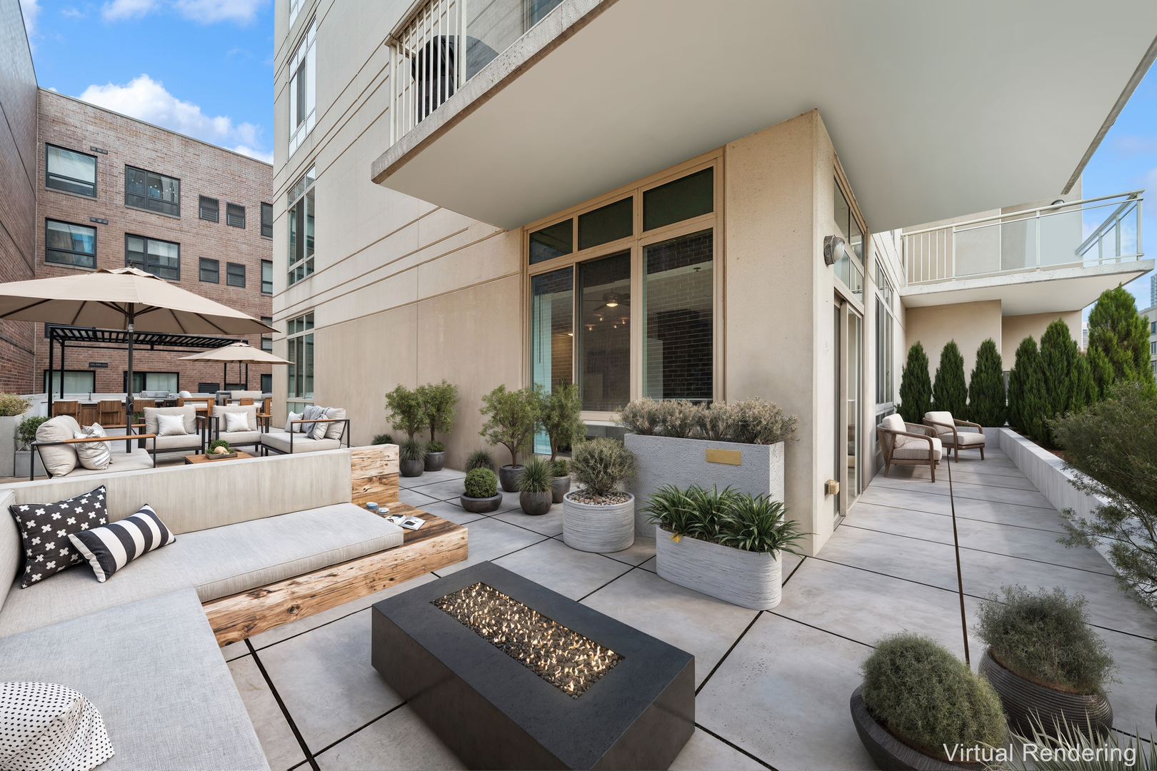 230 West Division Street, Unit 501 Chicago, IL 60610 - Photo 2 of 27 a view of a patio with couches table and chairs under an umbrella with a fire pit