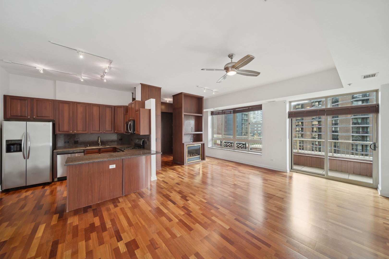 230 West Division Street, Unit 501 Chicago, IL 60610 - Photo 8 of 27 a large kitchen with stainless steel appliances granite countertop a refrigerator oven a sink dishwasher and a refrigerator with wooden floor