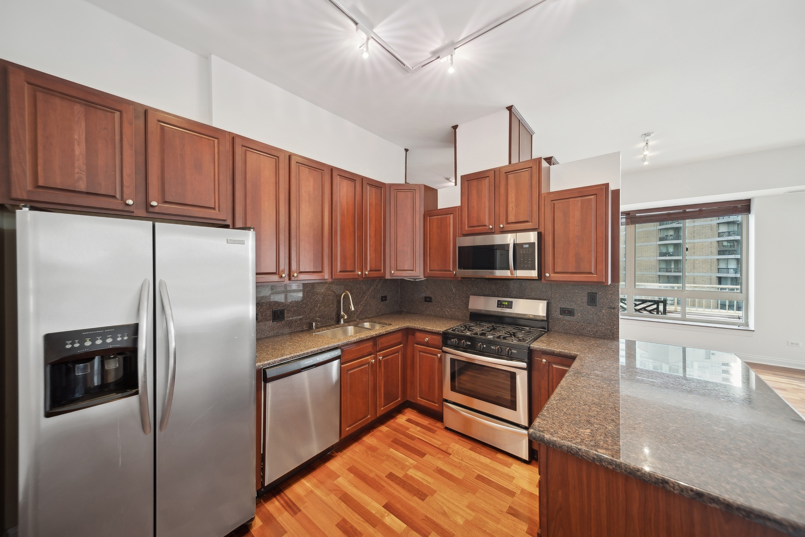 230 West Division Street, Unit 501 Chicago, IL 60610 - Photo 9 of 27 a kitchen with stainless steel appliances granite countertop a refrigerator a stove top oven a sink and dishwasher