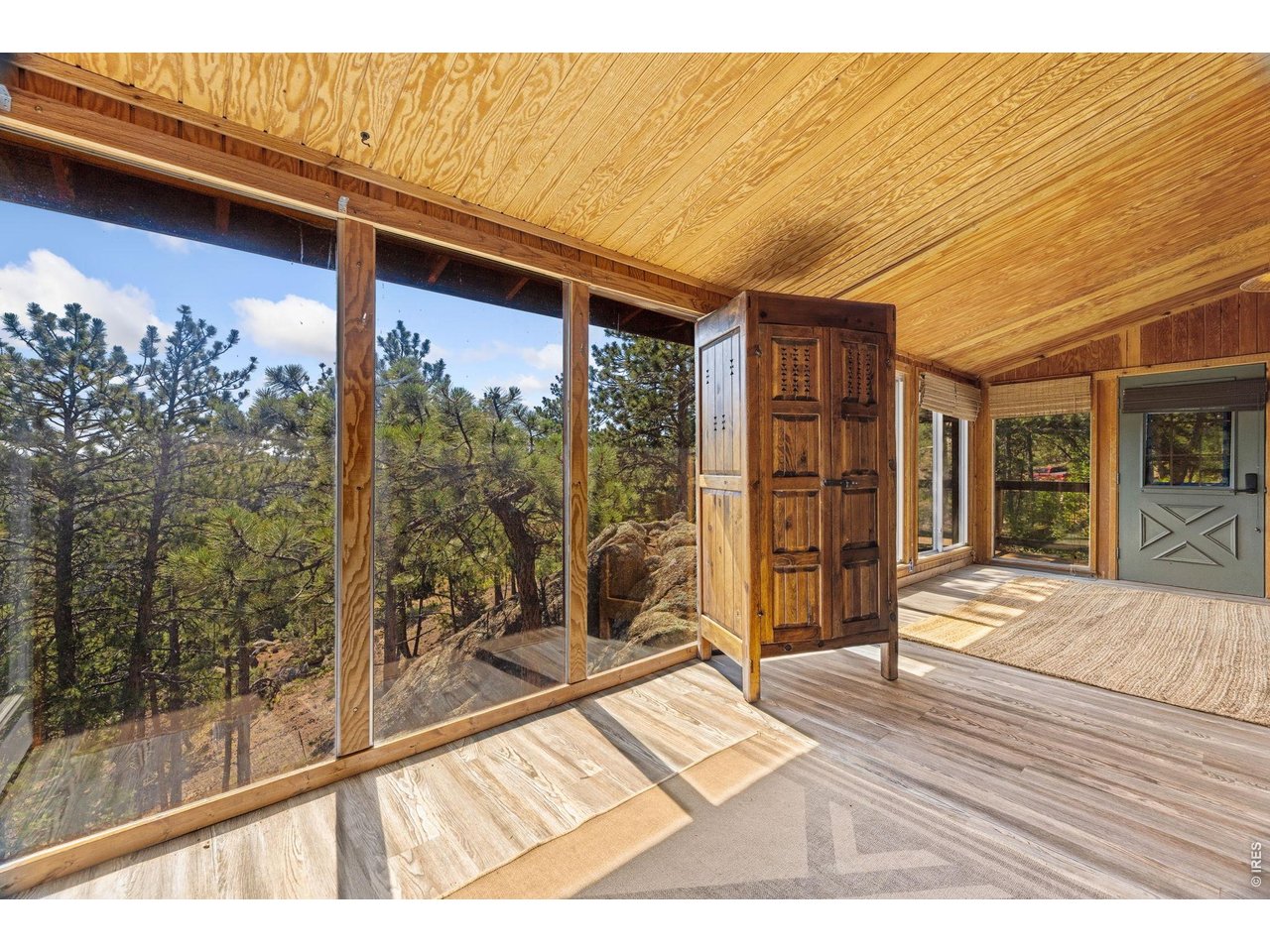 128 Elk Road Lyons, CO 80540 - Photo 14 of 50 Sunroom with expansive floor to ceiling windows to watch the wildlife go by