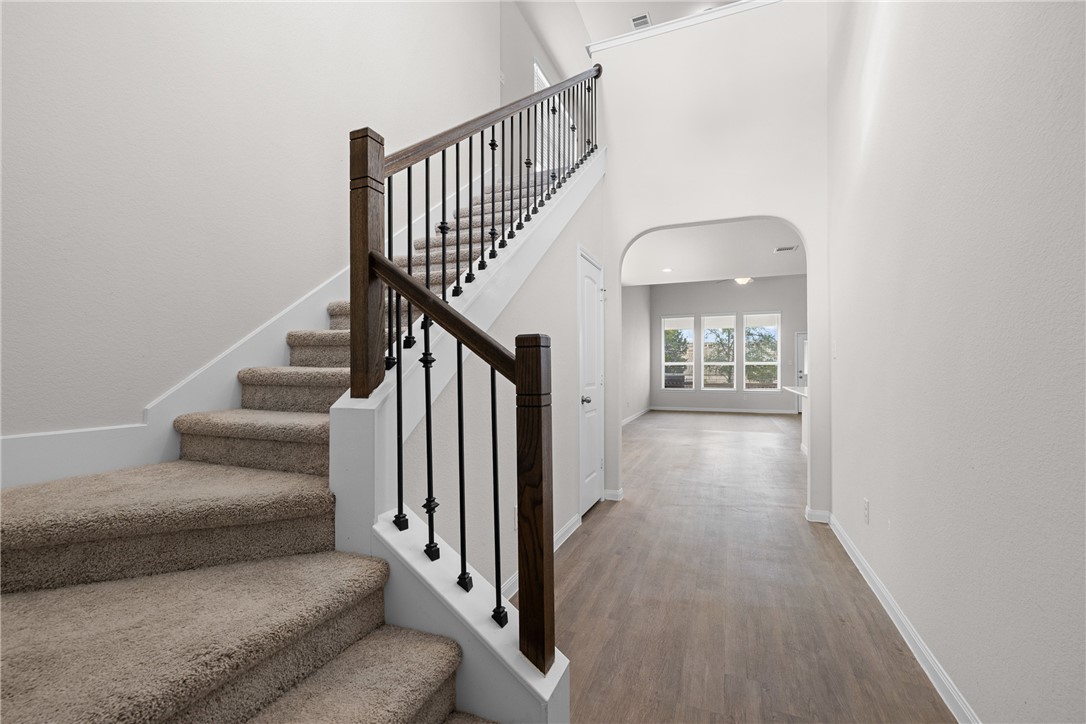 4702 Nopalitos Way Bryan, TX 77807 - Photo 18 of 27 a view of staircase with wooden floor and a rug
