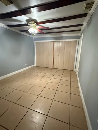a view of a livingroom with an empty space and a window