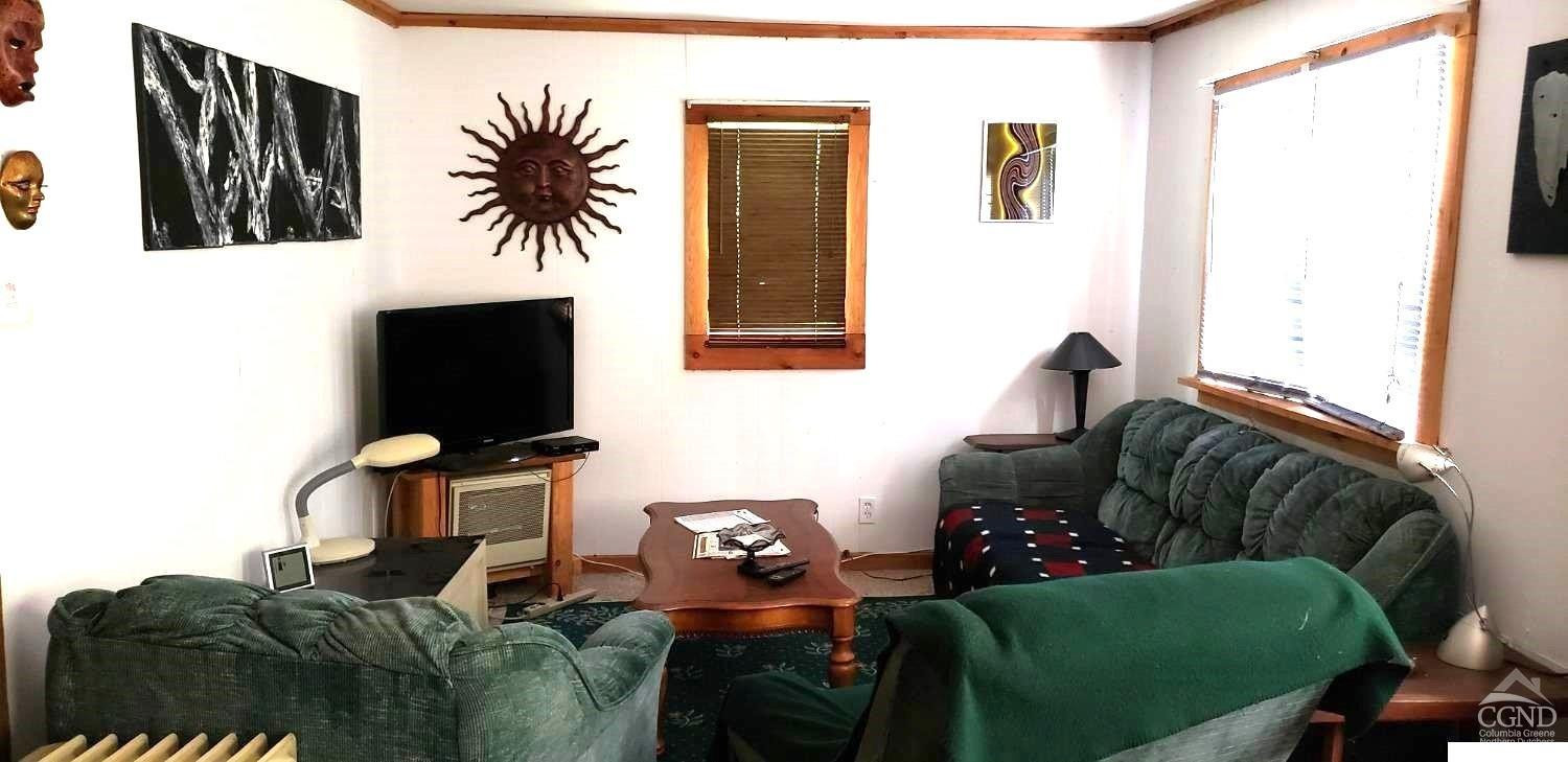 705 County Route 353 Rensselaerville, NY 12147 - Photo 4 of 5 a living room with furniture and a flat screen tv