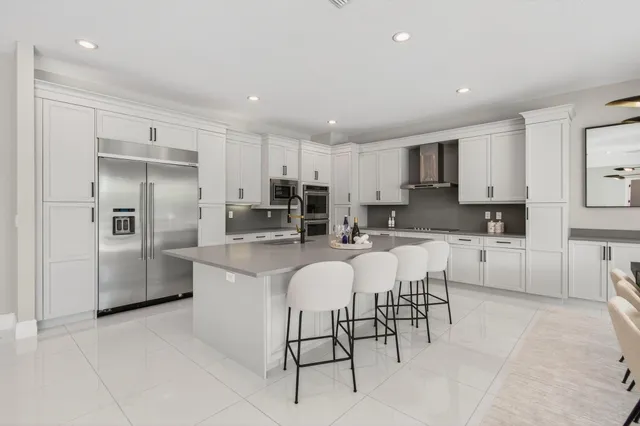 a bedroom with a bed chandelier and a window