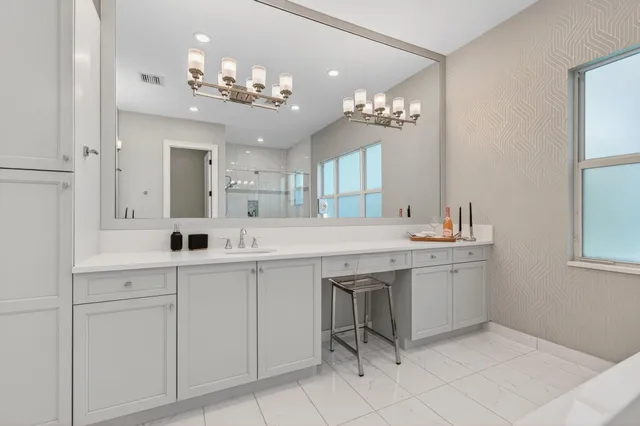 a living room with furniture and large windows