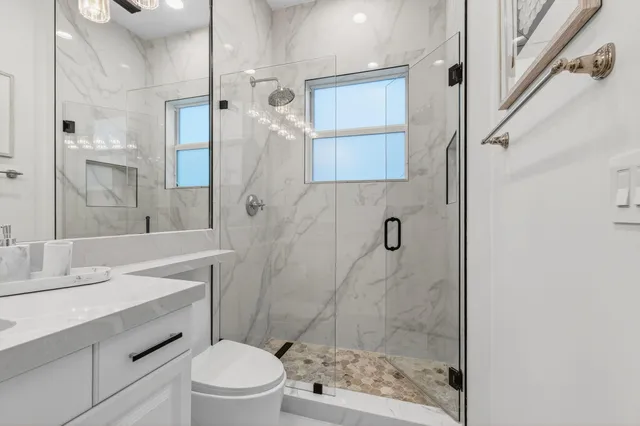 a front view of a house with a yard and potted plants