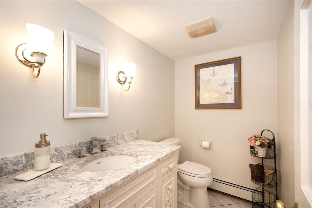 18 Longmeadow Road Scituate, MA 02066 - Photo 18 of 37 a bathroom with a granite countertop sink mirror vanity and toilet