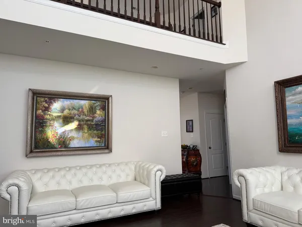 a living room with furniture a fireplace a rug and a large window