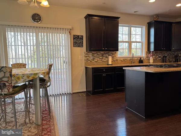 a kitchen with granite countertop a sink stove and cabinets