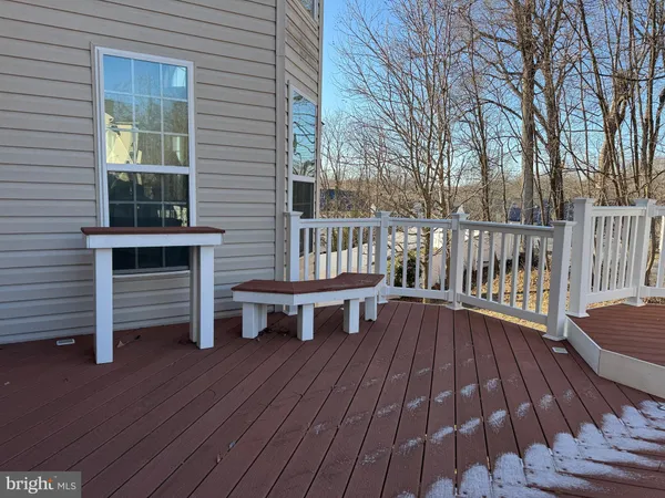 a view of balcony with wooden floor and outdoor seating